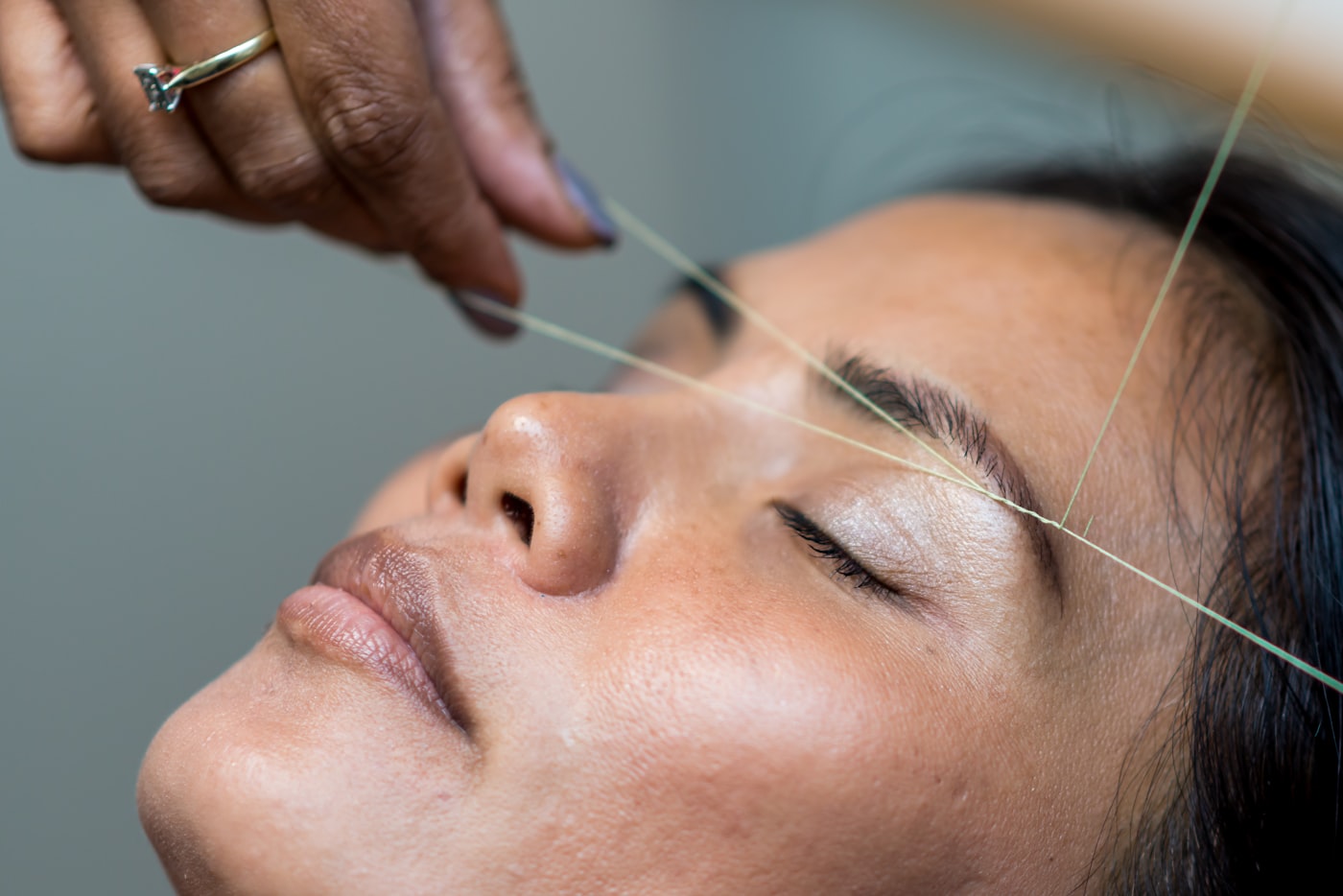 Client checking in at a salon reception desk