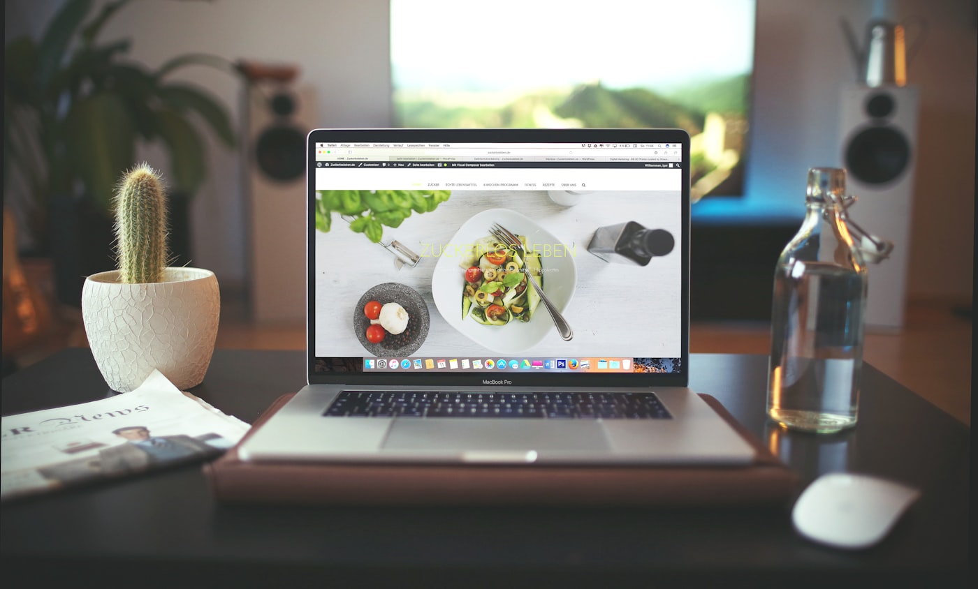 A designer’s workspace with design tools and a laptop